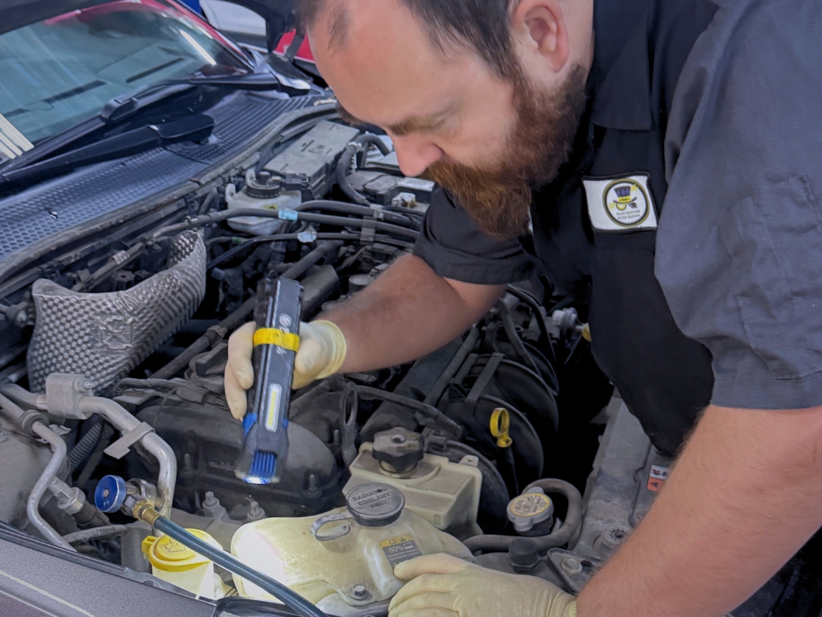 Mad Hatter Auto Repair technician diagnosing a car overheating problem